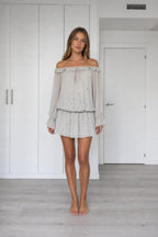 Front view of model wearing grey off-the-shoulder chiffon mini dress