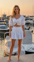 Front view of woman wearing white floral lace two-piece set by marina