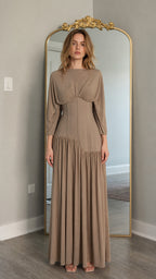 Front view of model wearing taupe long-sleeve maxi dress with corset waist
