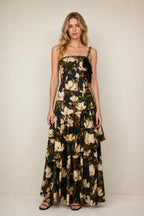 Front view of floral print tiered maxi dress in black on a model