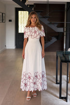 Front view of white off-the-shoulder floral embroidered maxi dress
