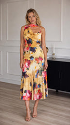 Model wearing yellow floral print satin midi dress from the front