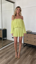 Front view of model wearing lime off-the-shoulder mini dress
