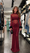 Woman wearing burgundy sheer mesh feather cuff maxi dress