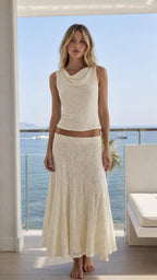 Model wearing cream lace cowl neck tank and maxi skirt set from the front
