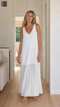 Front view of woman wearing white sleeveless maxi dress