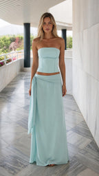 Front view of light blue strapless corset top and draped maxi skirt set