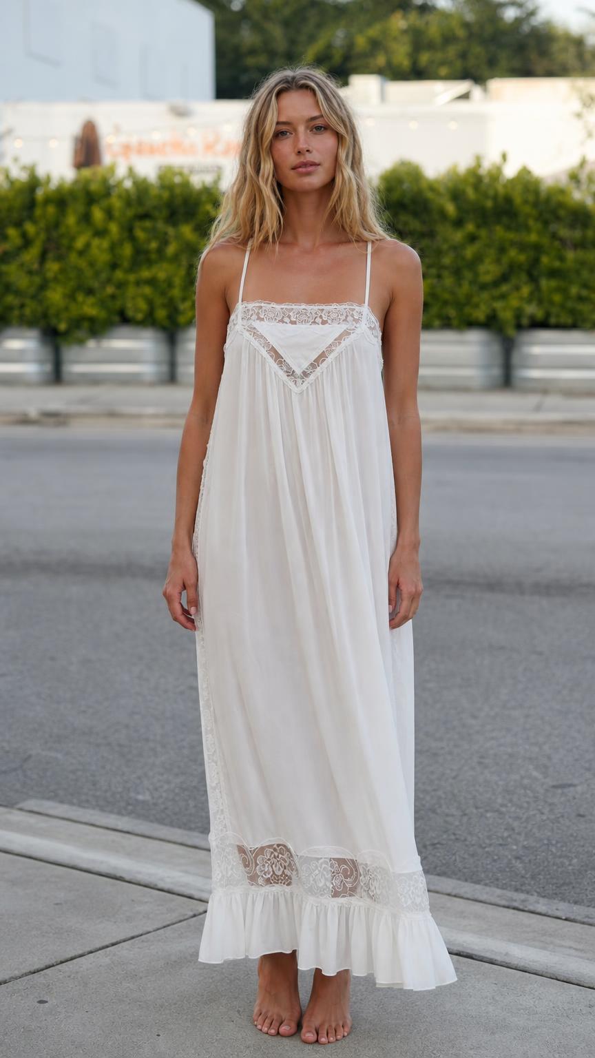 Front view of model wearing white bohemian lace trimmed maxi slip dress