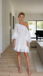 Front view of model wearing white one-shoulder ruffle lace mini dress
