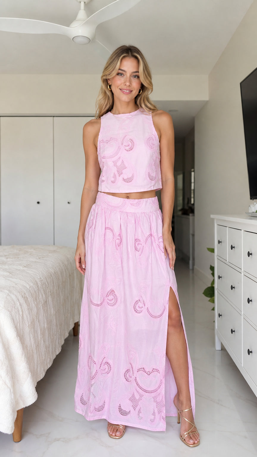 Front view of model wearing pink two-piece crop top and maxi skirt set