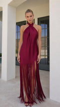 Model wearing burgundy satin halter fringe maxi dress front view
