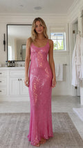 Model wearing hot pink sequin maxi slip dress from the front