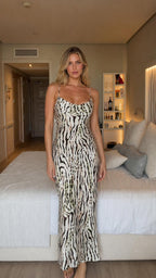 Front view of model wearing white animal print cowl neck maxi dress