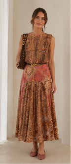 Front view of a printed sleeveless belted midi dress in warm rust tones