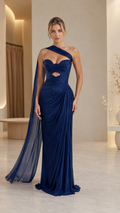 Front view of navy one-shoulder evening gown with cape