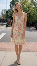 Front view of woman wearing Cream floral tiered dress with sandals