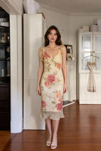 Front view of woman wearing cream floral ruffle midi dress