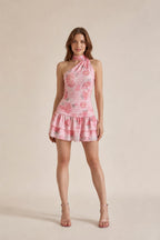 Front view of model wearing pink one-shoulder floral mini dress