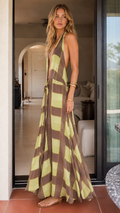 Woman wearing olive plaid halter maxi dress front view