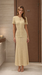 Model wearing beige textured knit top and maxi skirt set from the front
