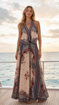 Front view of beige boho floral print halter maxi dress on yacht