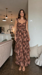 Front view of model wearing brown floral ruffle tiered maxi dress