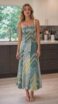 Model wearing teal printed cami midi dress front view