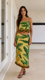 Front view of yellow tropical print cami top and maxi skirt set with fringe trim