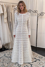 Front view of woman wearing white crochet lace maxi dress