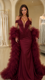 Model wearing burgundy halter neck mermaid evening gown with matching feather stole