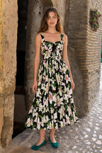 Front full view of black floral midi dress worn by model outdoors