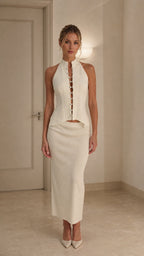 Model wearing ivory crystal embellished halter top and midi skirt set from front