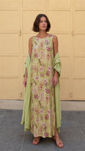 Model wearing olive floral print sleeveless maxi dress with matching wrap from the front