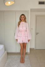 Model wearing pink long sleeve mini dress from the front
