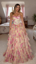 Front view of model wearing yellow floral strapless corset maxi dress