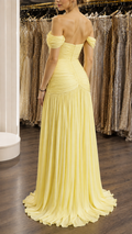 Model wearing yellow off-shoulder ruched formal evening dress back view