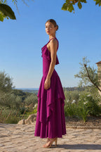 Side profile view of fuchsia maxi dress in outdoor setting