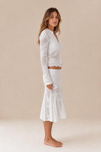 Side profile view of white crochet lace two-piece outfit