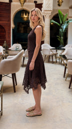 Side profile view of dark brown lace tank and asymmetric skirt set