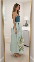 Side profile view of sage green strapless maxi dress