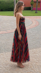 Side profile of model in multi-color pleated maxi dress