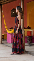 Side profile view of black mosaic print halter maxi dress