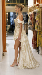 Side profile view of Champagne gown showing asymmetrical hem