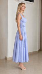 Side profile of model in light blue midi dress with lace-up waist