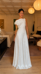 Front angle view of white textured one-shoulder floor-length gown