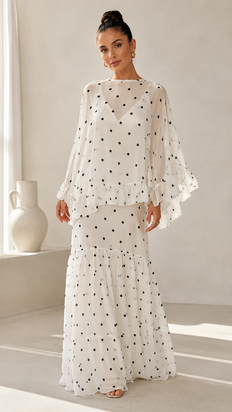 Front view of white polka dot chiffon maxi dress with layered silhouette