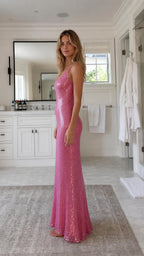 Model wearing hot pink sequin maxi slip dress from the side profile