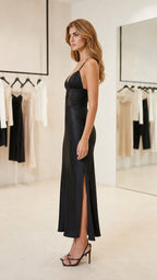 Side view of woman in Black satin slip maxi dress showing side slit
