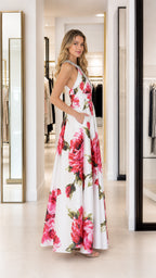 Side profile view of white floral maxi dress with pockets