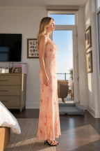 Side profile view of peach floral maxi dress